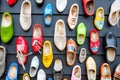 Dutch shoes - klomps. A lot of colorful old clomps against the background of a wooden wall. Popular souvenirs. Traditions of Royalty Free Stock Photo