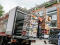 Dutch street scene with large truck unloading multiple drinks on the platform to