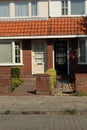 dutch street village architecture house bush brick neighbourhood facade white windows doors brown roof estate enter Royalty Free Stock Photo