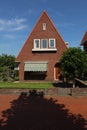 dutch street village architecture house bush brick neighbourhood facade white windows doors brown roof estate pavement Royalty Free Stock Photo