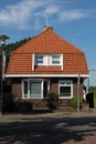 dutch street village architecture house bush places europe brick neighbourhood facade white windows doors brown roof estate Royalty Free Stock Photo