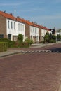 dutch street village architecture house bush places europe brick neighbourhood facade white windows doors brown roof estate paveme Royalty Free Stock Photo