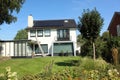 dutch street village architecture house bush places neighbourhood facade white solar panel windows doors brown roof estate