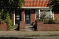 dutch street village architecture house europe brick neighbourhood facade white windows doors brown roof estate pavement sidewalk Royalty Free Stock Photo