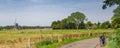 Dutch summer panorama with windmill and bike