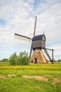 Dutch thatched stone hollow post mill with wooden upper house or