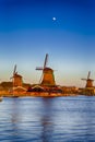 Dutch Travel Concepts. Three Traditional Dutch Windmills in the Village of Zaanse Schans at Daytime in the Netherlands Royalty Free Stock Photo