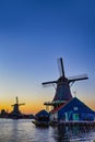 Dutch Travel Concepts. Two Traditional Dutch Windmills in the Village of Zaanse Schans at Daytime in the Netherlands Royalty Free Stock Photo