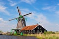 Dutch typical landscape. Traditional old dutch windmill with house blue sky in the Zaanse Schans village, Netherlands. Famous tour