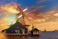 Dutch typical landscape. Traditional old dutch windmills against blue cloudy sky in the Zaanse Schans village, Netherlands during