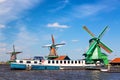 Dutch typical landscape. Traditional old dutch windmills with cruise ship and blue sky in the Zaanse Schans village, Netherlands.