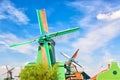 Dutch typical landscape. Traditional old dutch windmills with house and against blue cloudy sky in the Zaanse Schans village, Neth Royalty Free Stock Photo