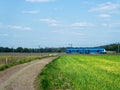 Dutch valeilein train. Blue passenger train. In farmlands.