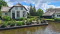 Dutch village with colorful ornamental garden and spring flowers, Giethoorn Royalty Free Stock Photo