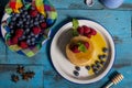 Dutch waffle breakfast with raspberry, blueberry and honey on blue wooden background. Isolated image. aerial shot. Breakfast