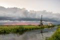 Dutch windmill against an upcoming stormy sky at sunset Royalty Free Stock Photo