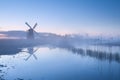 Dutch windmill in dense sunrise mist