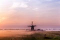 Dutch windmill in fog in the early morning Royalty Free Stock Photo