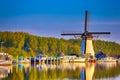 Dutch Windmill In Front of The Canal With Moored Motorboats at Marina Located in Traditional Village in The Netherlands. Shot at Royalty Free Stock Photo