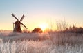 Dutch windmill at frosty winter sunrise Royalty Free Stock Photo