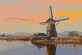 Dutch windmill landscape at the edge of a canal Royalty Free Stock Photo