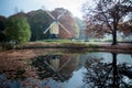 Dutch post windmill with reflection in the water