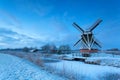 Dutch windmill on snow in winter dusk Royalty Free Stock Photo