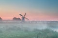 Dutch windmill in summer morning fog Royalty Free Stock Photo