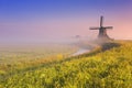 Dutch windmill at sunrise on a foggy morning