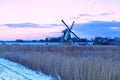 Dutch windmill in winter at sunrise Royalty Free Stock Photo