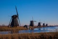 Dutch windmills reflecting in the canal water in Kinderdijk Holland