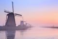 Dutch windmills at sunrise in winter at the Kinderdijk Royalty Free Stock Photo