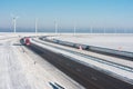Dutch winter landscape with highway along wind turbines Royalty Free Stock Photo
