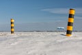 Dutch winter landscape with snowy farmland and colorful road signs