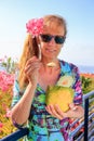 Dutch woman eating melon near pink oleander Royalty Free Stock Photo