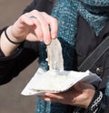 Dutch woman is eating typical raw herring