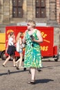 Dutch woman with Fujifilm camera on Dam Square, Amsterdam, netherlands.