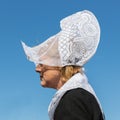 Dutch woman with traditional clothing and headgear at local fair