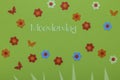 The Dutch word Moederdag Mothers day with small paper flowers on a green background Royalty Free Stock Photo