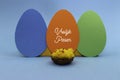 Dutch words Vrolijk Pasen with three paper eggs Royalty Free Stock Photo