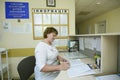 On duty. Nurse sitting at a doctor station and writing in a paper, hospital. Kyiv, Ukraine Royalty Free Stock Photo