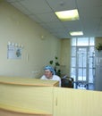 On duty. Nurse sitting at a doctor station and writing in a paper Royalty Free Stock Photo