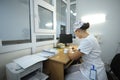 On duty. Nurse sitting at a nurseÃ¢â¬â¢s station and writing in a paper Royalty Free Stock Photo