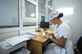 On duty. Nurse sitting at a nurseÃ¢â¬â¢s station and writing in a paper Royalty Free Stock Photo