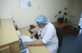 On duty. Nurse sitting at a nurses station and writing in a paper Royalty Free Stock Photo