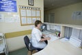 On duty. Nurse sitting at a nurses station and writing in a paper Royalty Free Stock Photo