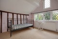 Iron Bed in room with leaded light windows