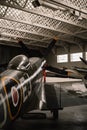Duxford England May 2021 Vertical shot of the back side of a spitfire inside a hangar, dark retro sepia colors