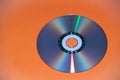 Dvd disk on an orange background. CD Royalty Free Stock Photo