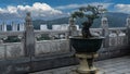 A dwarf bonsai tree grows in an ornamental pot next to a stone fence. Royalty Free Stock Photo